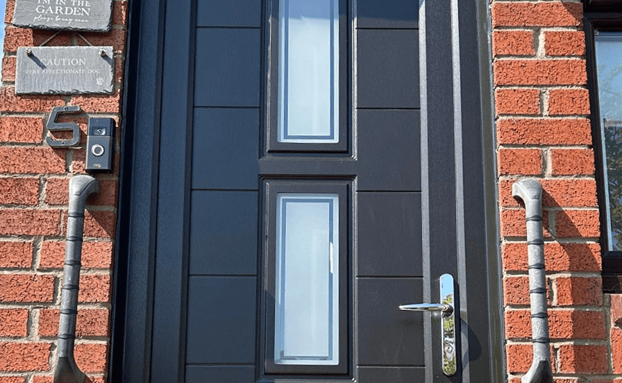 black upvc front door on brick house